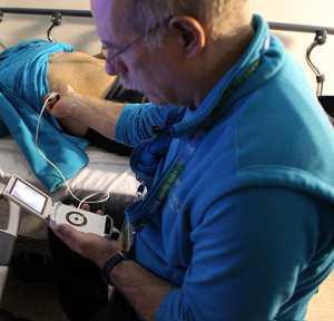 Dr Ross Brown examines a patient using a pocket-sized ultrasound at the Vancouver 2010 Winter Olympics.